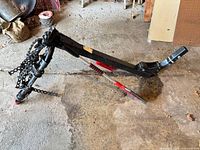 Full view of Yakima hitch bike rack laying on floor with two snow brush scrapers