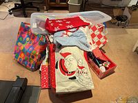 Overall lot showing bags, tree skirt, stocking, wrapping supplies