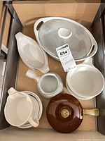 Drawer view of assorted CorningWare French White pieces with brown lidded pot