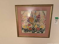 Full view of framed floral needlepoint on wall