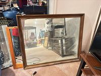 Full view of rectangular wood framed mirror front