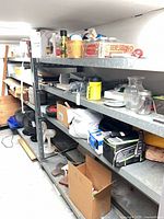 Full view of first steel shelving unit with contents for scale