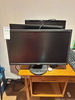 Front view showing Acer V243H monitor with another monitor behind it