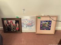 All three framed prints leaning against wall