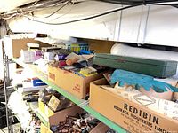 Shelf showing vent filter pack, boxes of fasteners, light bulb boxes and assorted hardware