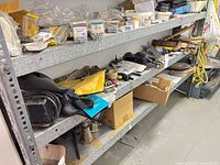 shelving holding varied tools, hardware, rope, wheels