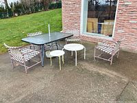 full view of dining table, four chairs, two side tables on patio