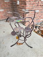 Front view of wrought iron plant stand showing lily pad platforms