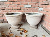 Both matching composite planters side by side on porch