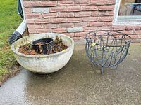 Concrete planter and wire stand on patio