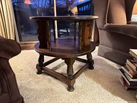 Full view of round two-tier end table showing legs, shelves, overall design