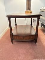 Full view of one side table front and shelf