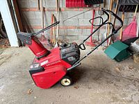 Full view of Honda HS621 snowblower showing body, handle, chute, wheels