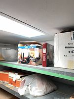 Shelf view showing boxed Trudeau fondue set and boxed glass bowl