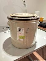 Crock with lid showing size sticker and blue "2" mark