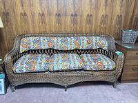 Front view showing full wicker sofa and cushions