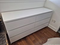 front angled view of white six-drawer IKEA dresser