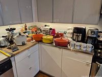 Overall lot on countertop showing appliances, Dutch ovens, crocks, mugs