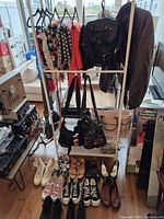 Overview of rack with clothing, bags, shoes