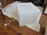 White cube light table front view with power cord visible
