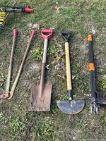 All four garden tools laid out on grass showing full length and condition