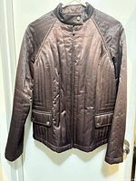 Front view showing full jacket, color, quilted pattern, pockets, zipper