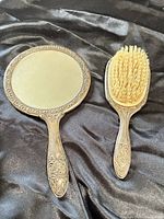 Front view of hand mirror and brush