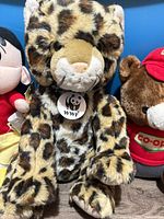 WWF leopard plush centered, Shin-chan and bear partially visible