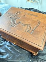 Top view showing carved animal motif on lid