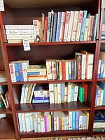 Four-shelf bookcase filled with assorted books