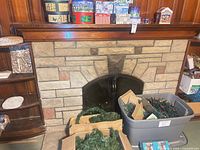 Overall view showing garland, storage tote, tins on mantel