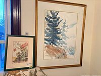 Both paintings: large landscape and small floral still life in frames