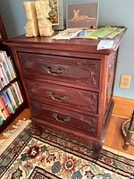 Front and right side view of 3-drawer carved wood side table