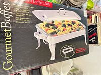 Front of box showing Gourmet Buffet 2-section covered chafing dish image and branding