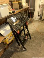Jobmate folding workbench folded against bench