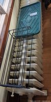 Metal shoe rack and plastic boot tray resting on radiator