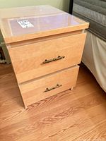 Front view of one nightstand showing drawers and handles