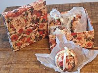 Lidded box and four matching baubles displayed on table