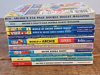 Stacked view of eight digest comics with their spines showing issue numbers and titles