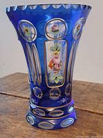 Front view showing enamel floral panel and oval cutouts