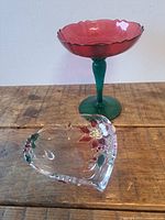 Red bowl green stem compote and clear heart dish on table