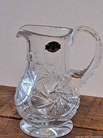Full view of crystal jug on wood surface