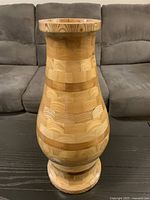 Full view of wooden segmented vase standing on table