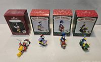 Group shot of four Disney Merry Miniatures figures with matching boxes