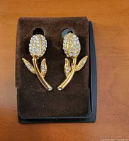 Front view of both earrings on velvet insert