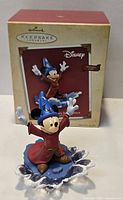 Front view of Mickey Mouse Sorcerer's Apprentice Hallmark ornament and original box
