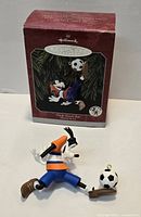 Goofy Soccer Star ornament lying in front of original Hallmark Keepsake box