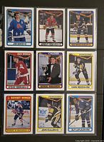 Nine hockey cards in plastic sleeve, front view showing all player images and card details