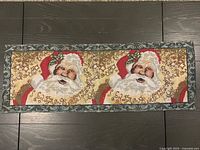 Front view of full tapestry table runner showing Santa motif and scripted text