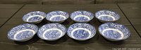 Eight blue and white Liberty Blue Betsy Ross plates arranged on table